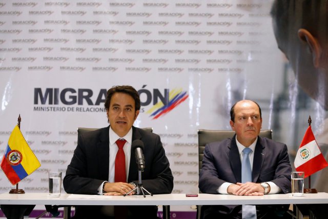 Christian Kruger, Colombia's Migration Director and Eduardo Sevilla, Peru's Migration Superintendent, speak at a news conference in Bogota