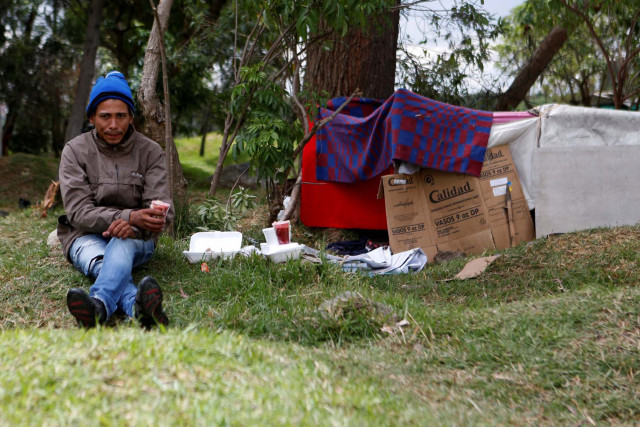 A Venezuelan migrant is seen in a makeshift camp near the transport terminal in Bogota