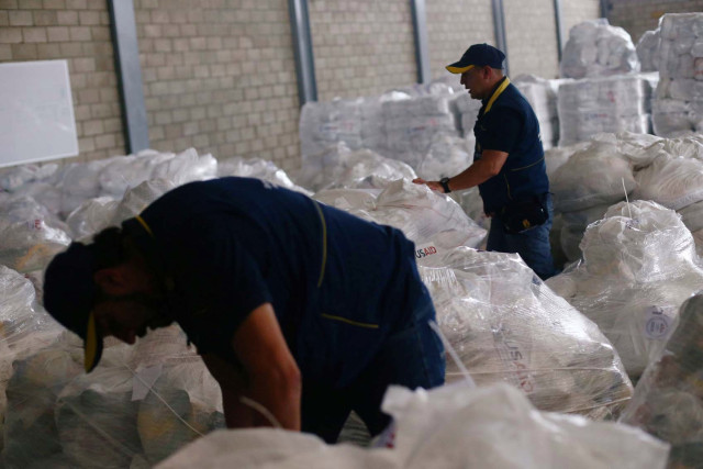 Workers organise humanitarian aid for Venezuela at a warehouse near the Tienditas cross-border bridge between Colombia and Venezuela in Cucuta